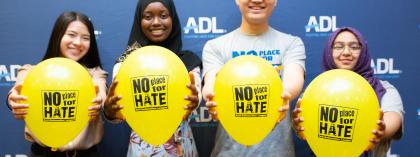 Students smiling holding balloons 