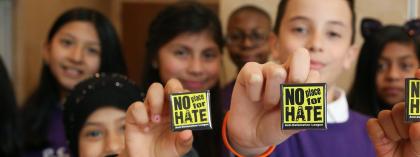 Students holding up no place for hate pins