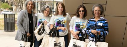 Female educators holding NPFH bags