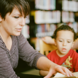 Teacher sitting with students at table