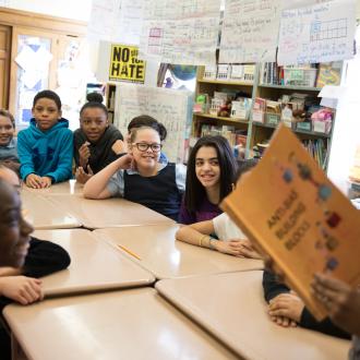 Teacher reading to young students