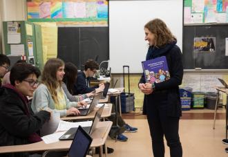 A teacher in front of her students in a classroom