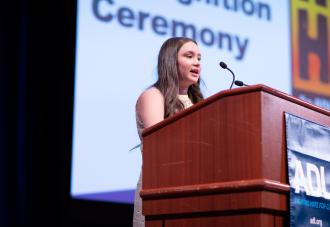 Student speaking at podium