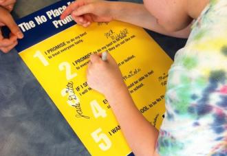 Student signing the pledge